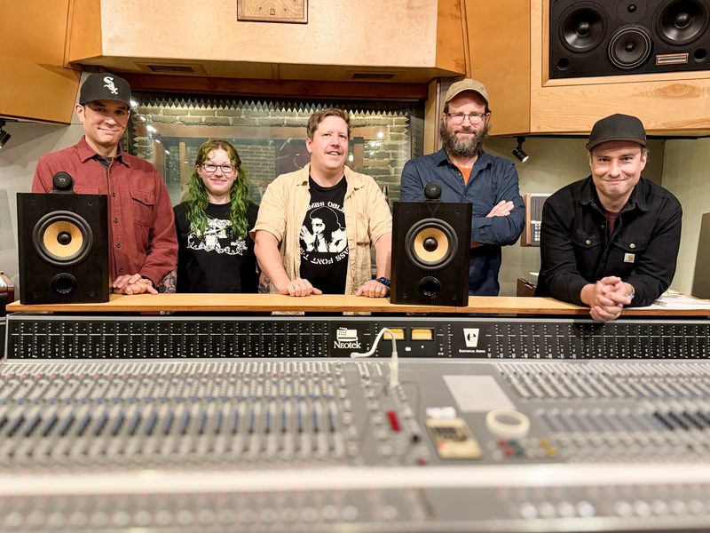 The Electrical Audio staff, left to right: Taylor Hales, Lauren MacDonald, Jon San Paolo, Greg Norman and Brian Fox, standing behind the Neotek console at Electrical Audio.